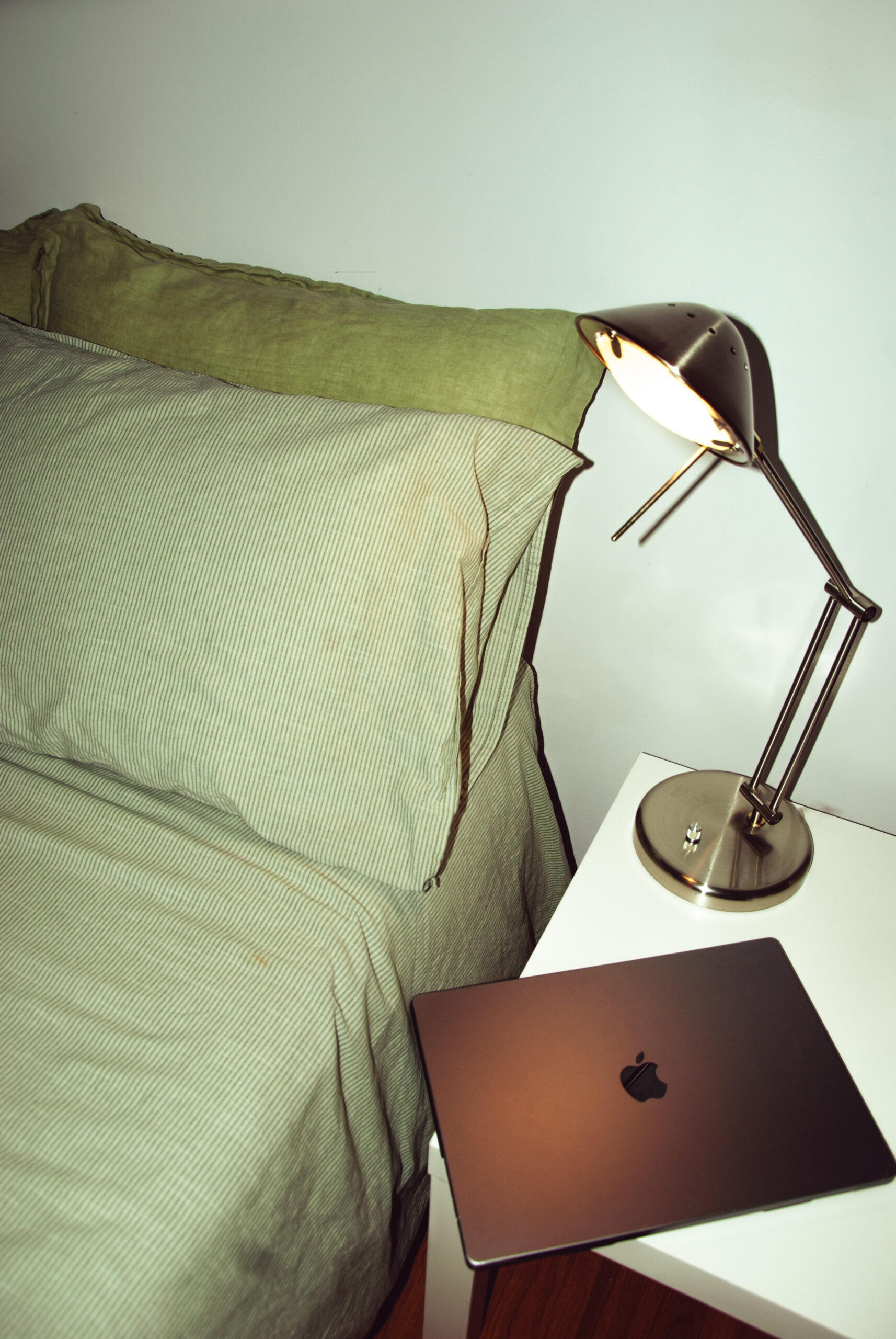 A laptop beside a bed in a blog post about social media marketing